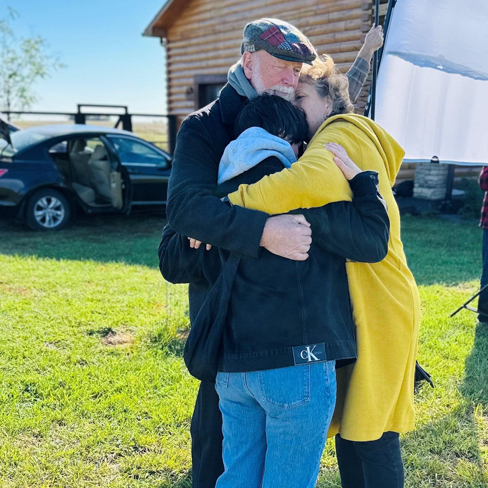 photo of Jenny, Ron, and Annie hugging